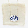 The birds of a feather vintage plate necklace styled on tan linen