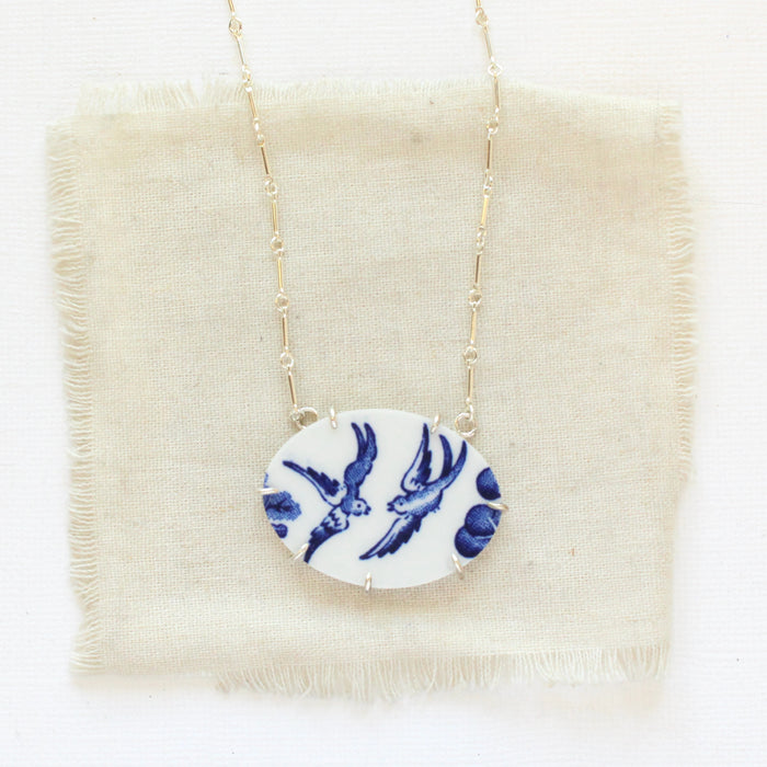 The birds of a feather vintage plate necklace styled on tan linen