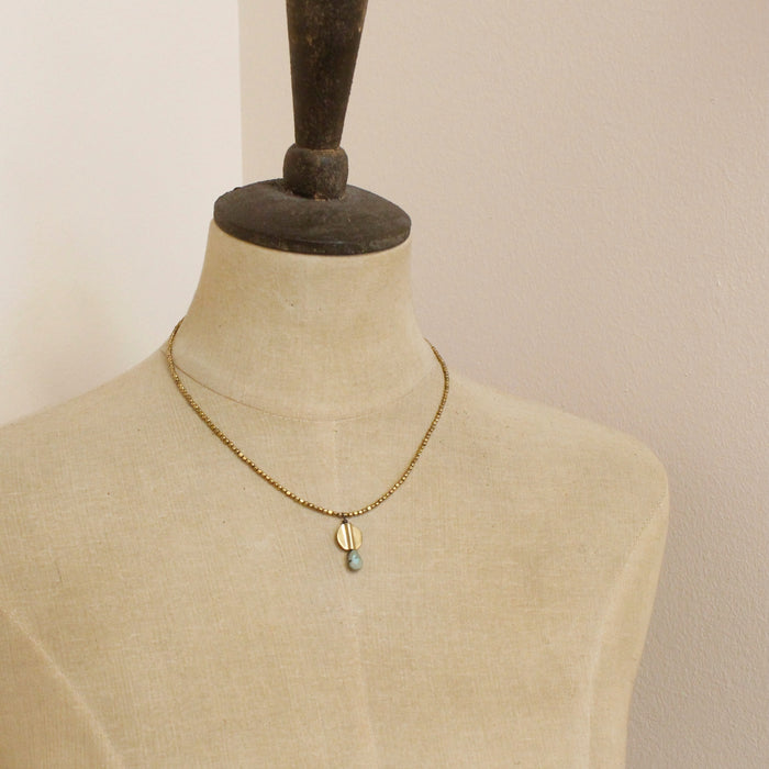 A mannequin wearing the brass and african jasper drop necklace
