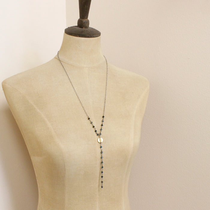 A mannequin wearing the grandidierite mythos lariat necklace 