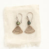 The bronze asmi triangle and african jasper earrings styled on tan linen