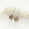 The bronze mini cactus flower lobe hugger earrings styled on rolled linen