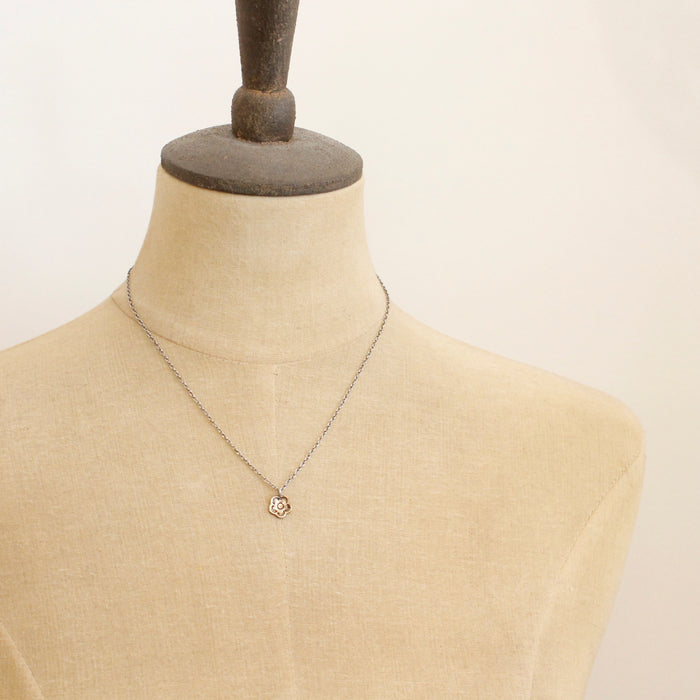 A mannequin wearing the bronze mini cactus flower necklace