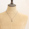 A mannequin wearing the bronze wanderer arch green apatite necklace 