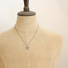 A mannequin wearing the bronze wanderer coin necklace
