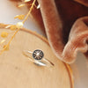 The columbine burst stacking ring styled on wood with orange velvet and dried grass