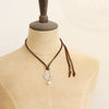 A mannequin wearing the columbine hoop pearl adjustable leather necklace in the short style
