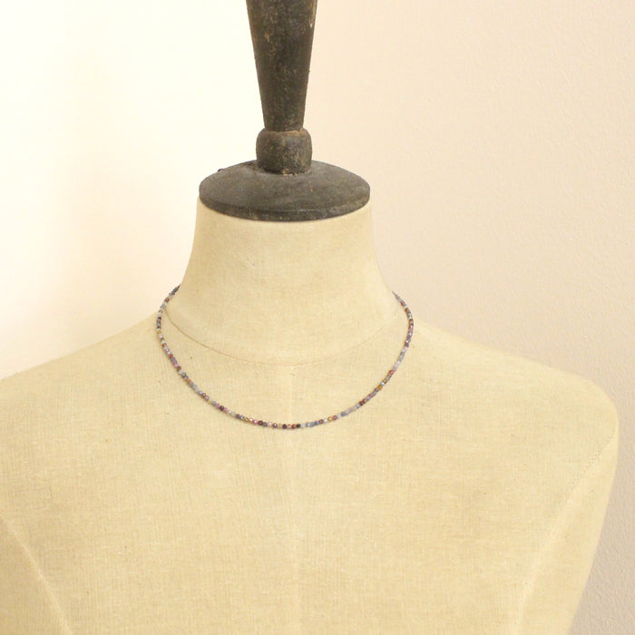 A mannequin wearing the dainty sapphire necklace