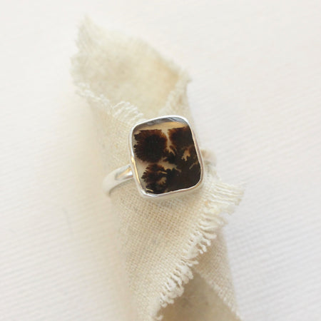 The dendritic agate ring styled on tan linen