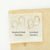 Shepherd hook earwires and leverback earwires are styled on a tan rock to show the earwire style options