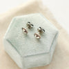 The silver heart earrings styled to show the butterfly ear backs