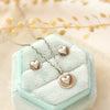The silver heart post earrings styled with the matching necklace on a blue velvet box