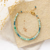 The lagoon double strand bracelet styled on a tan rock with linen and dried grass