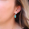 The feminine turquoise petal post earrings being worn