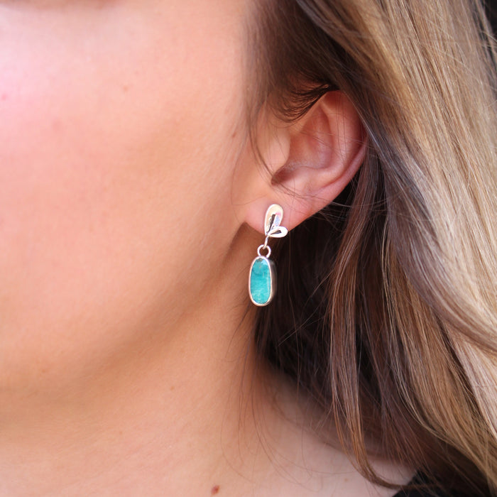 The feminine turquoise petal post earrings being worn