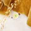 The flower vintage plate ring styled with yellow velvet and dried grass