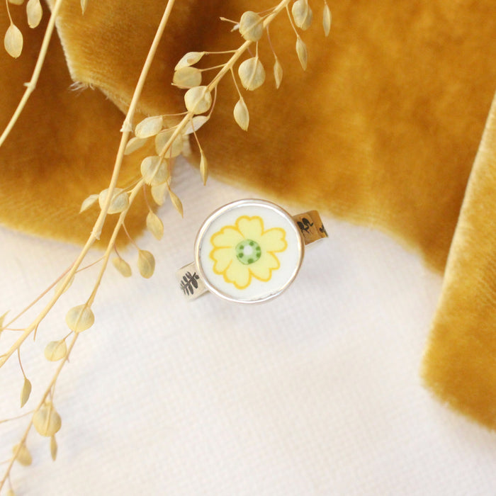 The flower vintage plate ring styled with yellow velvet and dried grass
