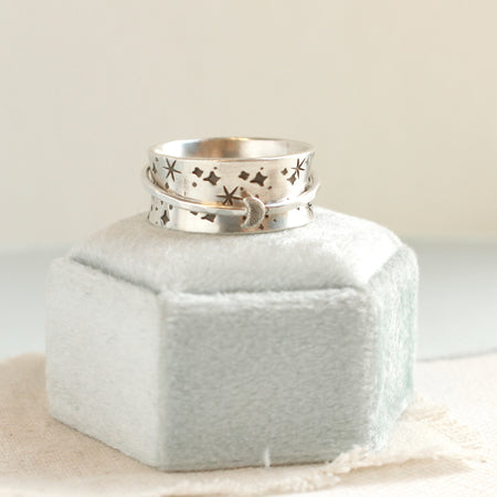 The galaxy spinner ring styled on a velvet box