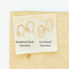 Shepherd hook earwires and leverback earwires styled on a tan rock to show earwire options