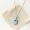 The back of the golden hills turquoise necklace styled on tan linen