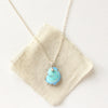 The golden hills turquoise necklace styled on tan linen