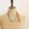 A mannequin wearing the short style of the apatite adjustable leather necklace
