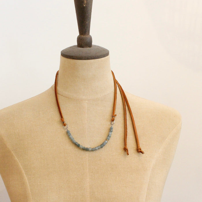 A mannequin wearing the short style of the apatite adjustable leather necklace