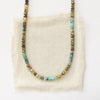 The beaded lana necklace styled on tan linen