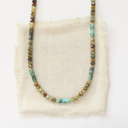 The beaded lana necklace styled on tan linen
