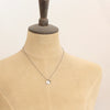 A mannequin wearing the green kyanite and sprout charm necklace