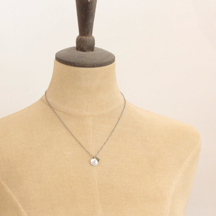 A mannequin wearing the green kyanite and sprout charm necklace