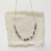 The herkimer diamond collar necklace styled on tan linen