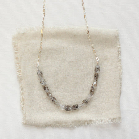 The herkimer diamond collar necklace styled on tan linen