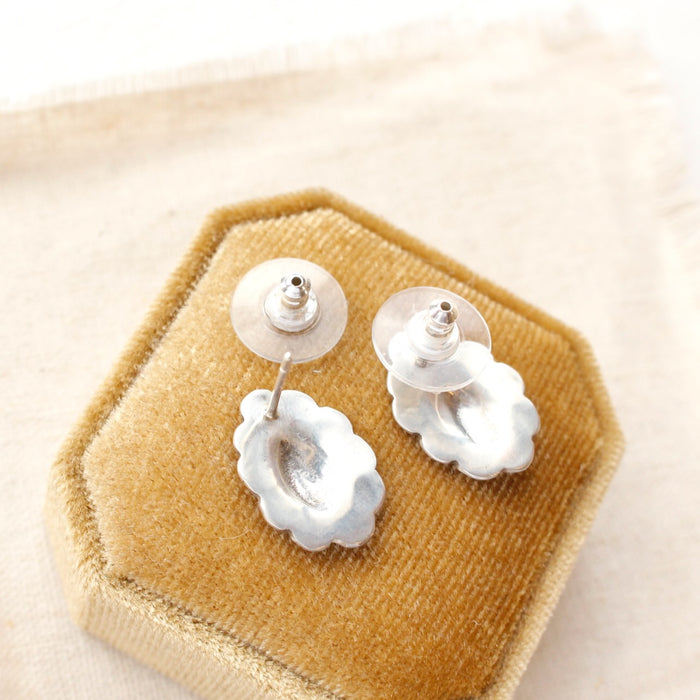 The jolene post earrings styled on a velvet box to show the post back and comfort clutch earbacks