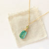 The kingman turquoise and peridot necklace styled on tan linen