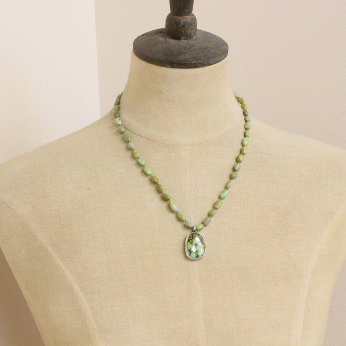 A mannequin wearing the knotted elisa and hubei turquoise necklace