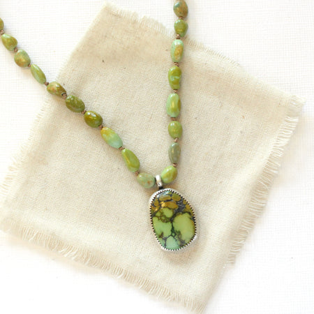 The knotted elisa turquoise and hubei turquoise necklace styled on tan linen