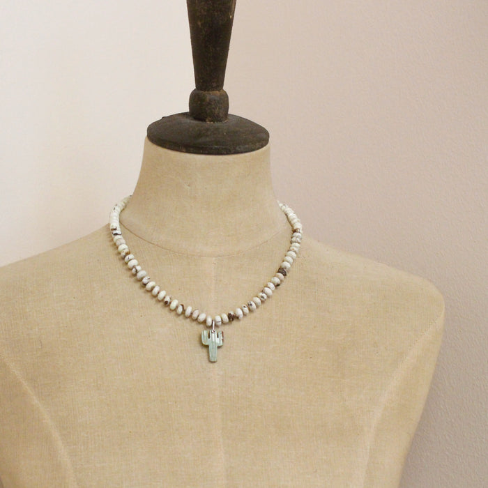 A mannequin wearing the knotted lemon chrysoprase and carved turquoise cactus necklace