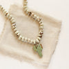The knotted lemon chrysoprase and carved turquoise cactus necklace styled on tan linen