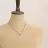 A mannequin wearing the knotted kaleidoscope leaf necklace 