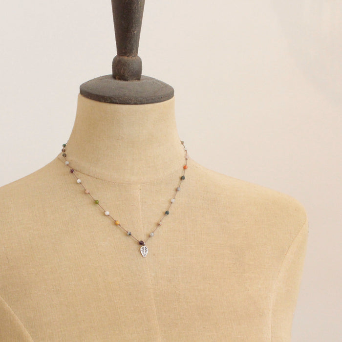 A mannequin wearing the knotted kaleidoscope leaf necklace 