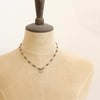 A mannequin wearing the knotted pyrite and bronze cactus flower necklace