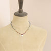 A mannequin wearing the knotted tourmaline heart necklace