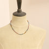 A mannequin wearing the knotted rainbow tourmaline necklace