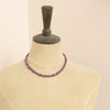 A mannequin wearing the knotted ruby nugget necklace