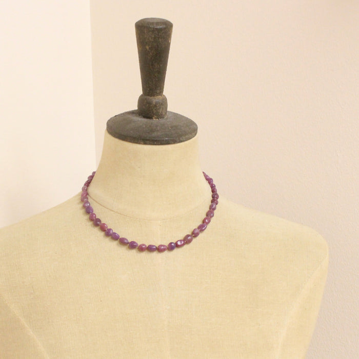 A mannequin wearing the knotted ruby nugget necklace