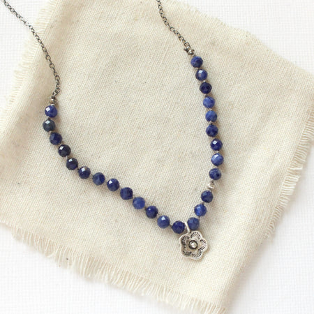 The knotted sodalite mini cactus flower necklace styled on tan linen