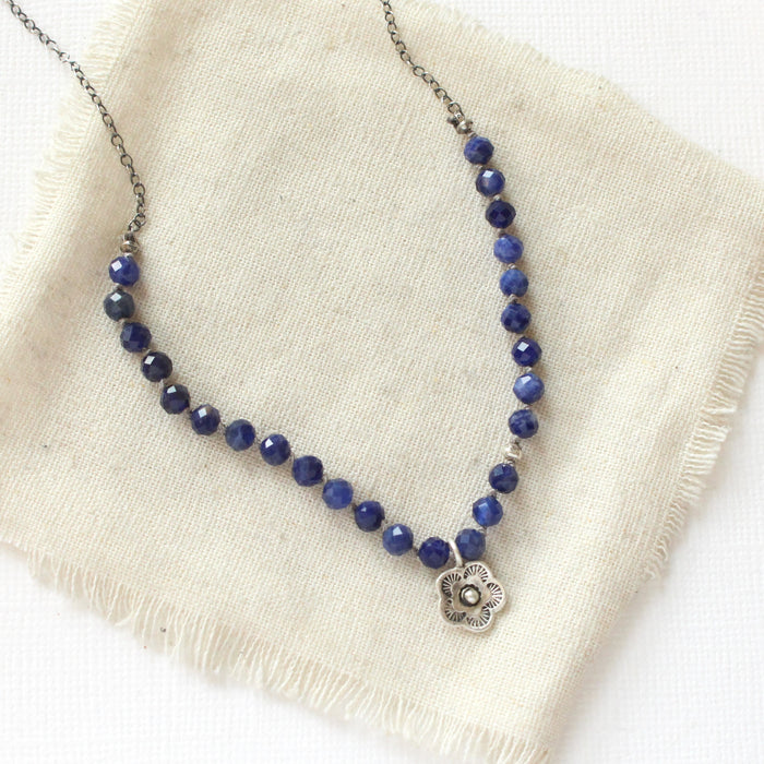 The knotted sodalite mini cactus flower necklace styled on tan linen