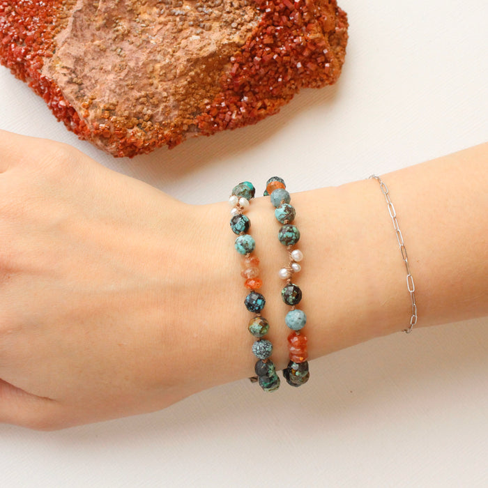 The knotted sunset bracelet being worn on a wrist