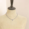 A mannequin wearing the knotted tanzanite mini cactus flower necklace